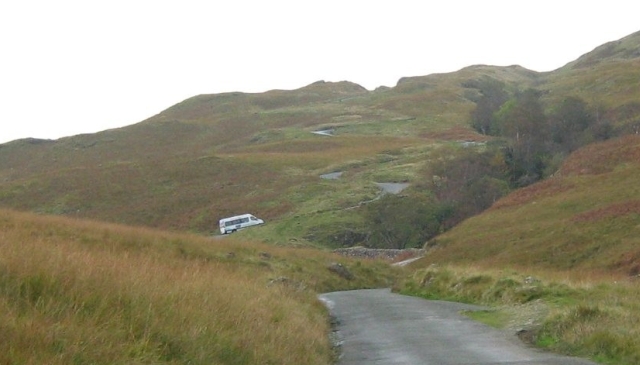 a coach climbing up the Hardknott Pass at a very steep angle